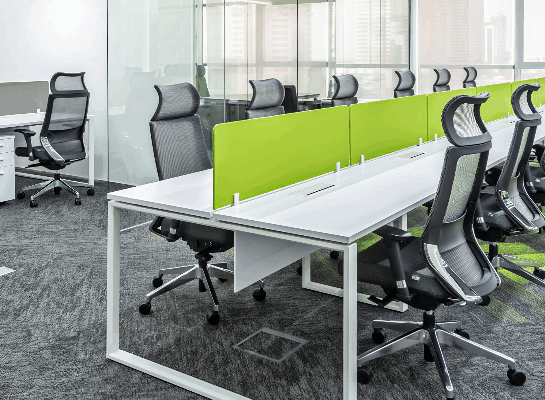 Row of height adjustable desks in a shared office environment